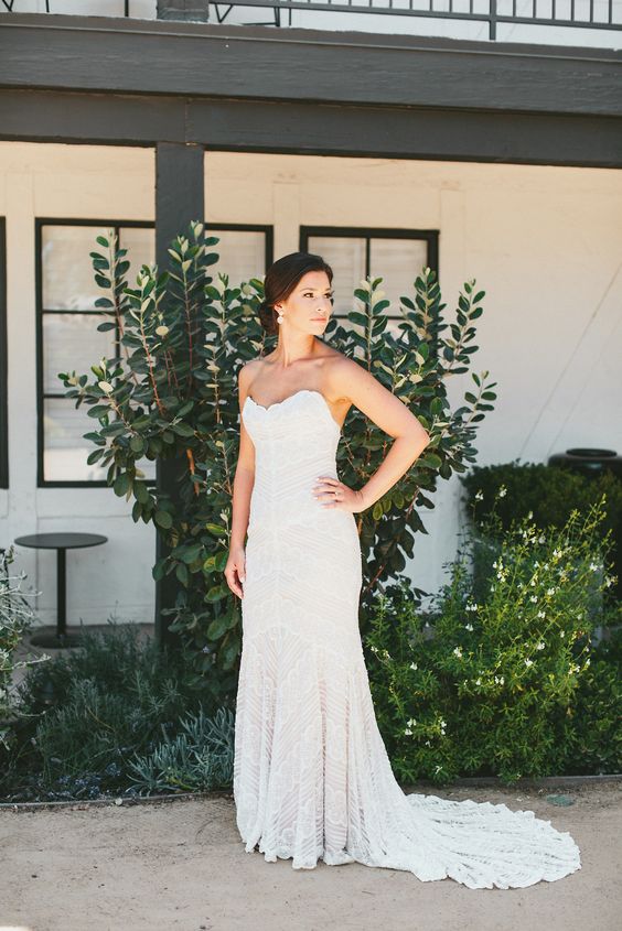 a strapless lace mermaid wedding gown with a scallop neckline and a train for a beautifully romantic look
