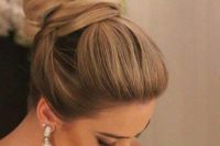 13 an elegant and sleek top knot with twisted elements and a bump on top for a formal wedding