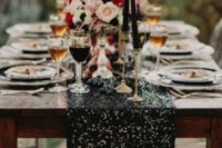 14 a black sequin table runner, black candles and little blooms for a bold moody wedding tablescape