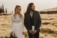 14 a boho couple with a groom wearing eye-catchy layered attire and a bride rocking a lace top and a pleated skirt