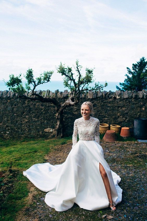 a sheer lace embellished wedding top with long sleeves and a plain full skirt with a side slit