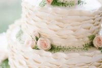 14 a sweet white ruffled wedding cake with blush and white roses and greenery