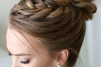 14 a wavy top knot with a braid on top is ideal to spruce up a traditional bun