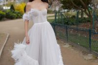15 a light and airy draped A-line wedding gown with a sweetheart neckline and feather detailing