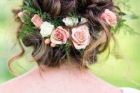 16 a curly braided updo with greenery and fresh blooms and some curls down for a messy feel