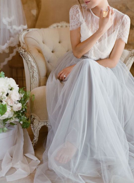 a subtle bridal look with a sheer lace top and short sleeves and a grey tulle maxi skirt
