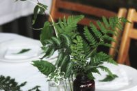 16 a table setting done with figs and ferns and foliage in vases and bottles for fresh fall feel