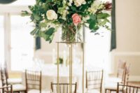 16 a tall and chic wedding centerpiece of white and pink blooms plus greenery on a tall gold stand