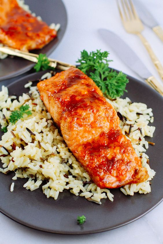 apricot glazed salmon served with rice and fresh herbs as an alternative to meat