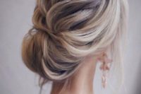 17 a beautiful loose braid into a bun with some locks down and much volume is very elegant