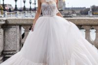 17 a romantic A-line wedding dress with a lace embellished bodice and a layered full skirt