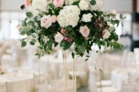 17 a tall hydrangea, lush greenery and rose wedding centerpiece in a gold modern vase