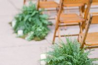 17 a wedding aisle with moss, ferns and candles for a natural touch, these plants won’t wilter