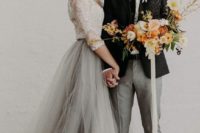 a white lace top with long sleeves and a grey tulle skirt is a chic and gentle idea for a bride