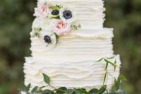 18 an elegant white ruffle wedding cake decorated with greenery and white and blush blooms