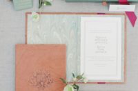 18 custom invitations in green wooden boxes with a leather-bound book and Italian paper