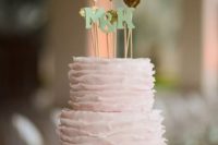19 a blush ruffle wedding cake with multiple gold glitter heart toppers and monogram ones
