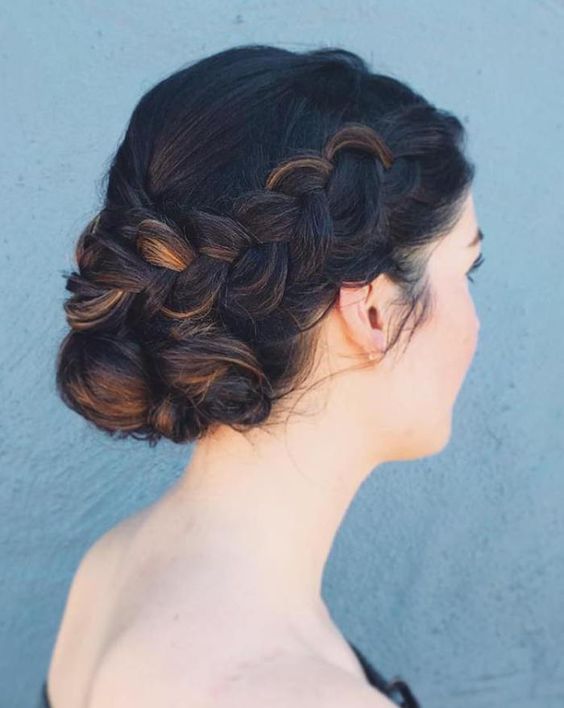 a large side braid with a low bun is a trendy and edgy idea for a boho bride or just for those who love braids