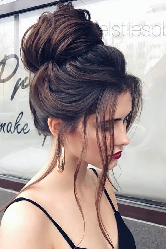 a large  top bun and some locks down is a striking idea if you have long and thick hair