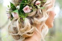 20 a low curly updo with curls down and blush roses and greenery to refresh the look