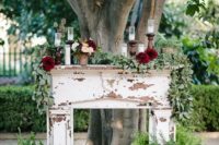 23 a shabby chic mantel decorated with candles, greenery, blooms, candle lanterns and foliage