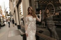 23 a sheer floral lce applique off the shoulder wedding gown with long sleeves and a mermaid silhouette