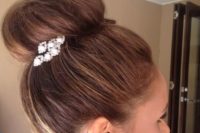 23 a top knot can be accented with a rhinestone and pearl hairpiece on one side and you may wear matching earrings