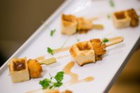 23 chicken and waffles bites with greenery are a cool bite idea for many weddings