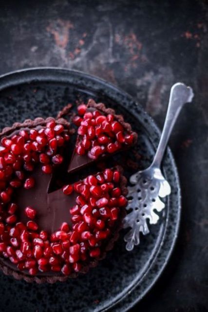 a decadent chocolate pomegranate berry tart is a delicious winter wedding dessert