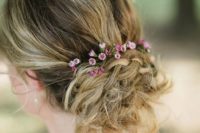 24 a textural messy updo with braids, a bump and little flowers to add a touch of color