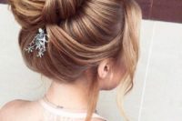 24 an elegant and chic twisted top knot with a dimension and texture and some locks down plus a hairpiece for an accent