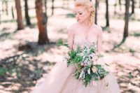 25 a strapless princess-style wedding gown with a layered tulle skirt and a lace bodice in tender blush color