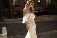 26 an off the shoulder sheer lace embellished fit and flare wedding dress with a train