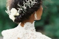 26 naturally curly hair with a twisted halo adorned with herbs and white blooms for a contrasting look