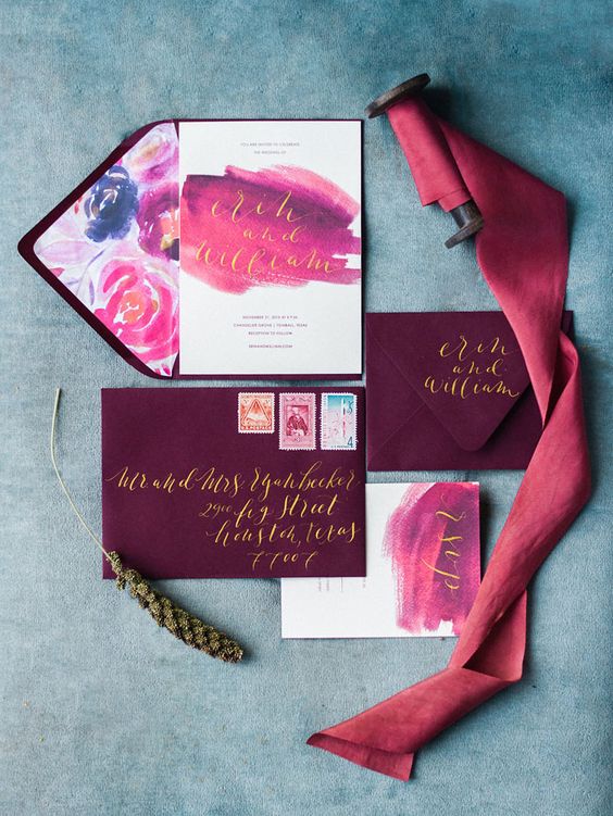 plum-colored envelopes, pink and purple watercolor wedding invites with gold calligraphy