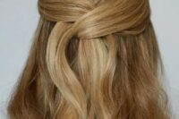 a beautiful and easy wrapped up half updo with a sleek top and waves down is a lovely idea