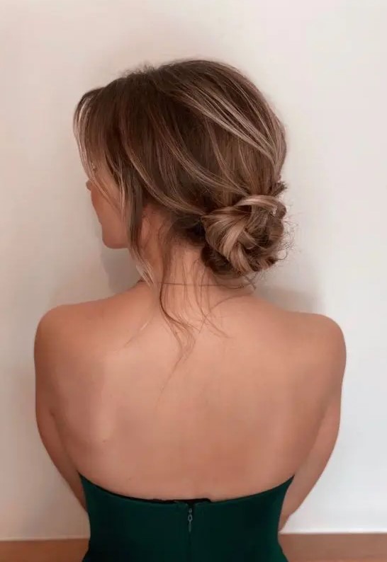 a beautiful knotted low bun with a bit of dimension and locks down is a stylish idea for a wedding