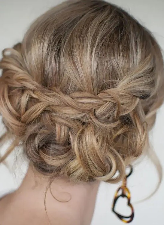 a boho updo with braids and twists and some waves down plus a bump on top is a stylish and cool idea