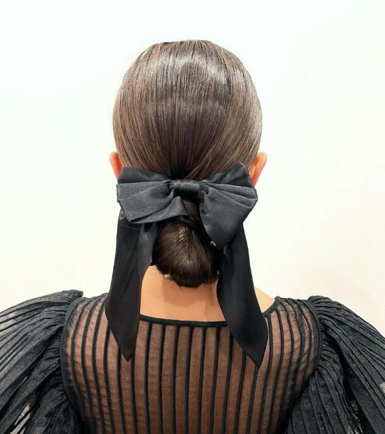 a bow tied chignon is a polished and chic idea, go for a satin or velvet bow according to your look and style