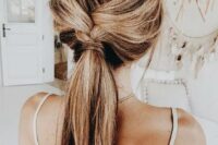 a braid going into a low ponytail with a bit of mess is great for a boho wedding