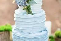 a buttercream ombre blue wedding cake with a large succulent on top and some greenery is a great idea for a vintage-inspired wedding