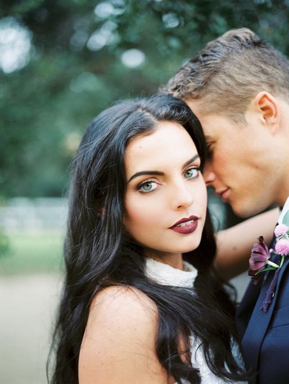 a dark burgundy lip makes a super bold statement and the bride stands out a lot