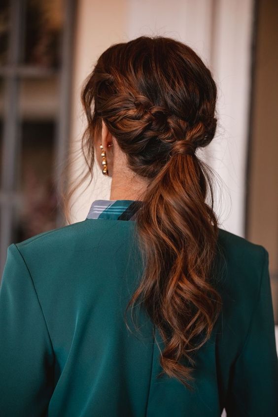 a low ponytail with a braid and some side bangs is a cool idea for a modern and chic look