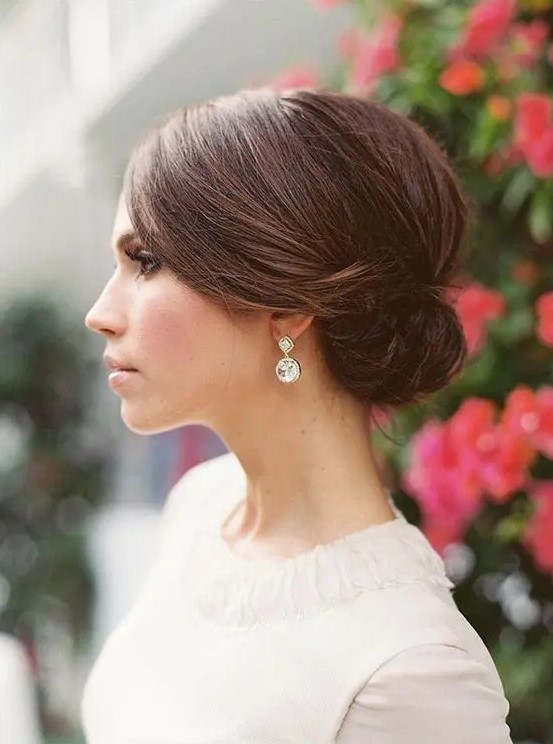 a low sleek sided bun is pure elegance and is suitable for a minimalist wedding