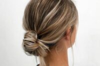 a messy low bun with a bump on top and some hair down is a chic and simple idea for a casual wedding guest look