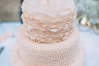 a neutral wedding cake with ruffle tiers and a ball one plus a wire topper is a cool and cute modern cake idea