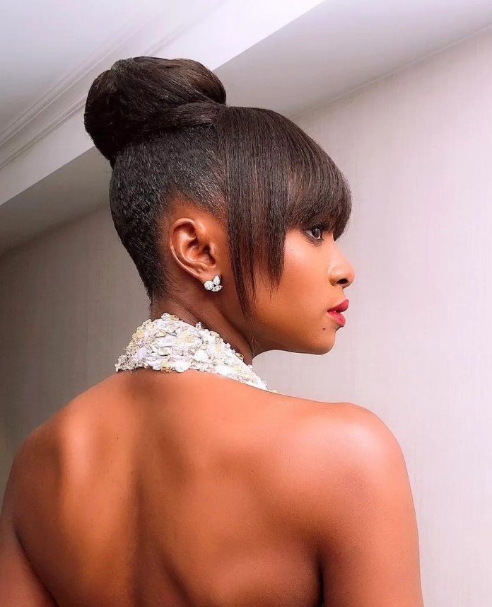 a sleek and sculptural updo with bangs, if you want a sleek finish, add hair gel to the hairstyle