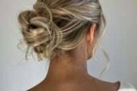 a soft, messy and loose updo with a sleek top and twisted hair plus some waves is a lovely idea for a wedding