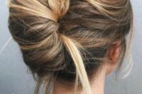 a super messy and bold French twist updo with a messy volume on top and enough mess in the twist