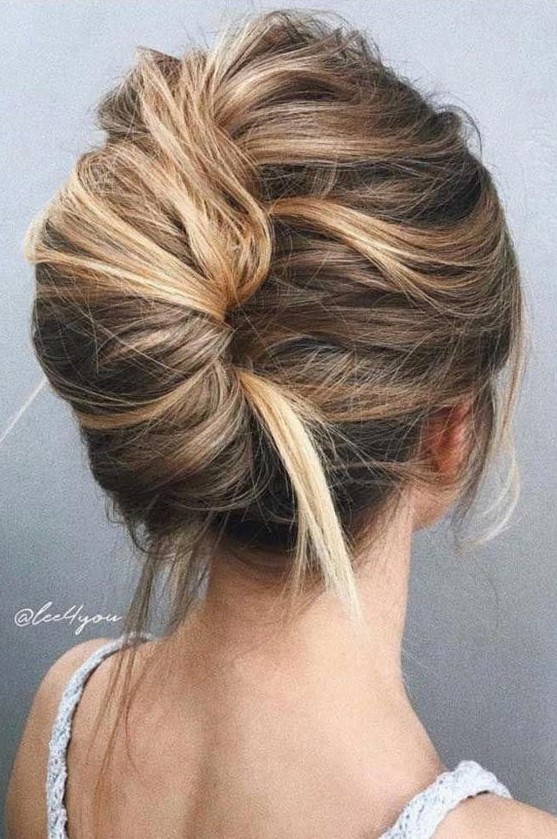 a super messy and bold French twist updo with a messy volume on top and enough mess in the twist